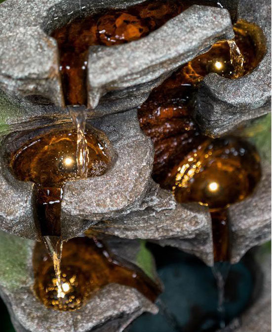 An airial view of the turned on multi-level rock cascading rock fountain